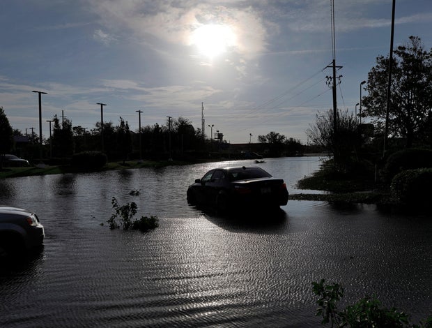 The sun reflects on flood water and stranded vehicles as it emerges after days of storm clouds and rain, in the aftermath of Hurricane Florence in Wilmington, North Carolina