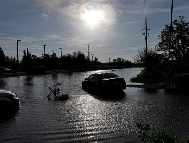 The sun reflects on flood water and stranded vehicles as it emerges after days of storm clouds and rain, in the aftermath of Hurricane Florence in Wilmington, North Carolina 