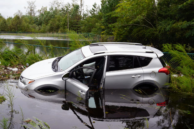 Partially submerged car is pictured on flooded street after Hurricane Florence struck Piney Green 