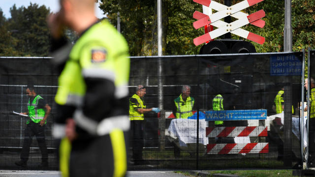Rescue personnel work at the scene where a train struck a "cargo bicycle" popular with Dutch parents to transport their children at the city of Oss 