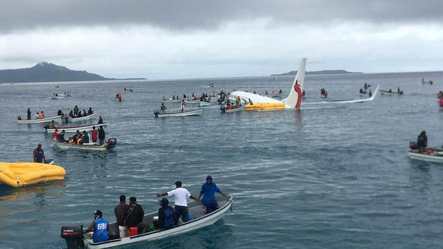 People are evacuated from an Air Niugini plane crashed in the waters in Weno, Chuuk, Micronesia 