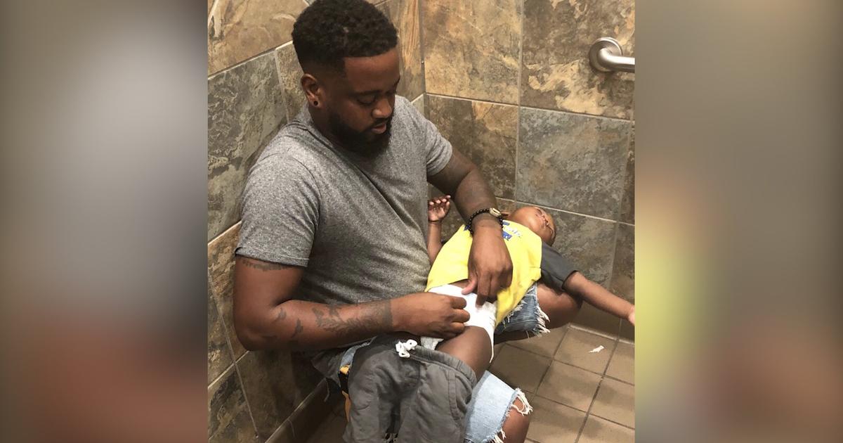 'Let's Fix This' Photo Of Dad Changing Baby's Diaper In Public