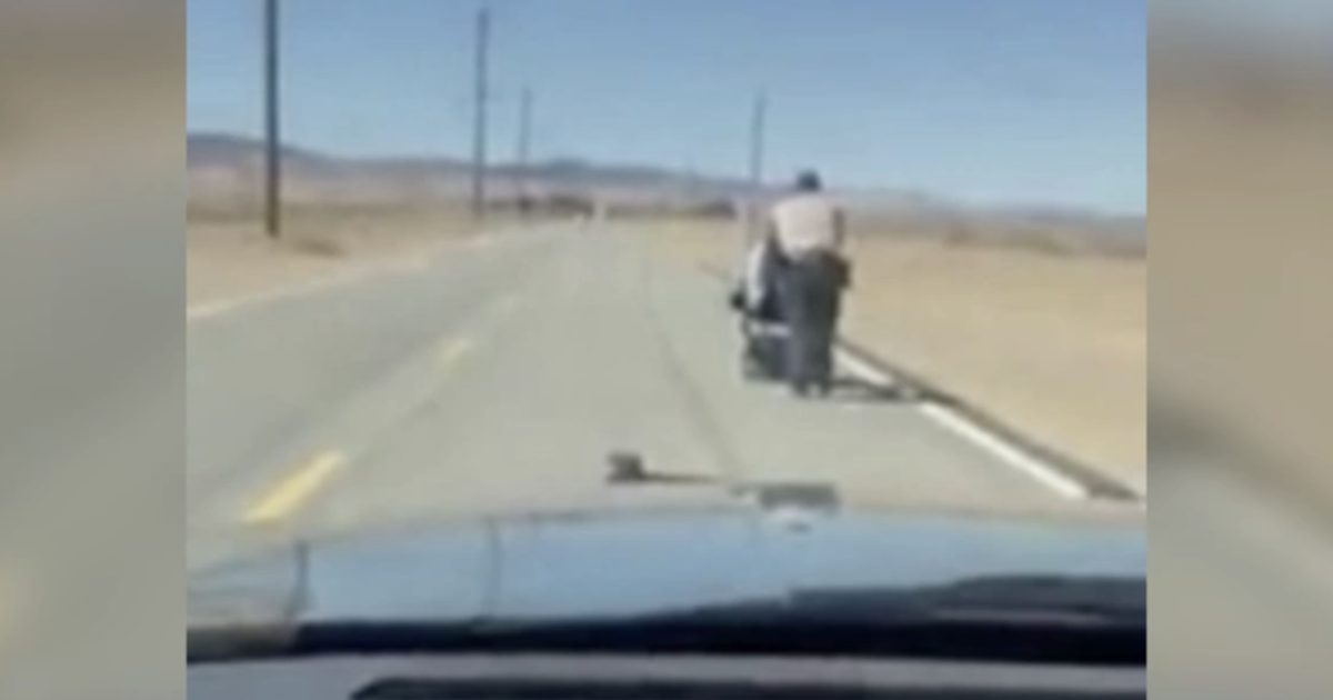 Deputy pushes stranded woman's wheelchair one mile to her home - CBS News