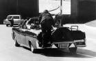 President John F. Kennedy slumps down in the back seat of the presidential limousine after he was fatally shot in Dallas on Nov. 22, 1963. Jacqueline Kennedy leans over the president as Secret Service agent Clinton Hill rides on the back of the car. 