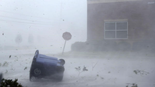 A trash can and debris are blown down a street by Hurricane Michael on Oct. 10, 2018, in Panama City, Florida. The hurricane made landfall on the Florida Panhandle as a Category 4 storm. 