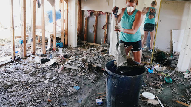 People clean up their house that was destroyed following Hurricane Michael in Mexico Beach 