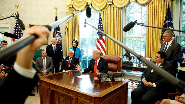 U.S. President Donald Trump speaks with workers on "Cutting the Red Tape, Unleashing Economic Freedom" in the Oval Office of the White House 