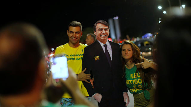 Supporters of Jair Bolsonaro react after Bolsonaro won the presidential race, in Brasilia 