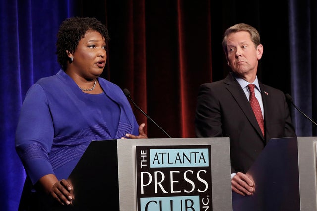 Democratic gubernatorial candidate for Georgia Stacey Abrams speaks as Republican candidate Brian Kemp looks on during a debate in Atlanta 