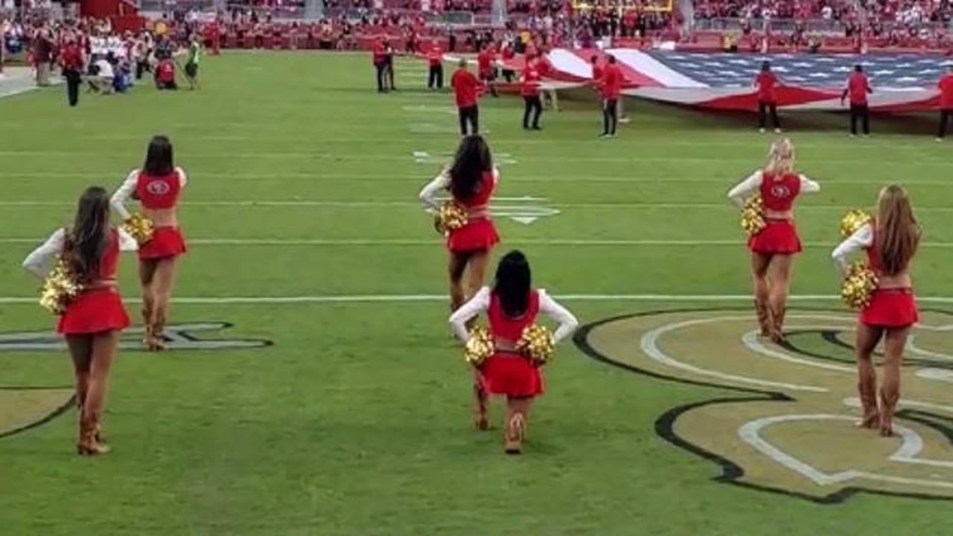 49ers cheerleader takes a knee during anthem before Raiders game