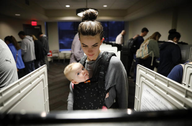 Kristen Leach votes with her 6-month-old daughter, Nora, on Election Day in Atlanta Nov. 6, 2018. 