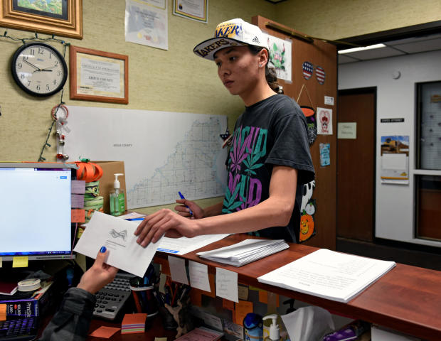 Terrell Elk, 18, votes for the first time by delivering his absentee ballot to the Sioux County auditor's office on the Standing Rock Reservation in Fort Yates, North Dakota, Oct. 26, 2018. 