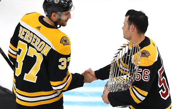 Boston Red Sox bring World Series trophy to Boston Bruins game - ESPN