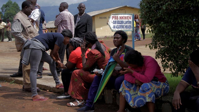 Parents await for news of their children at a school where 79 pupils were kidnapped in Bamenda 