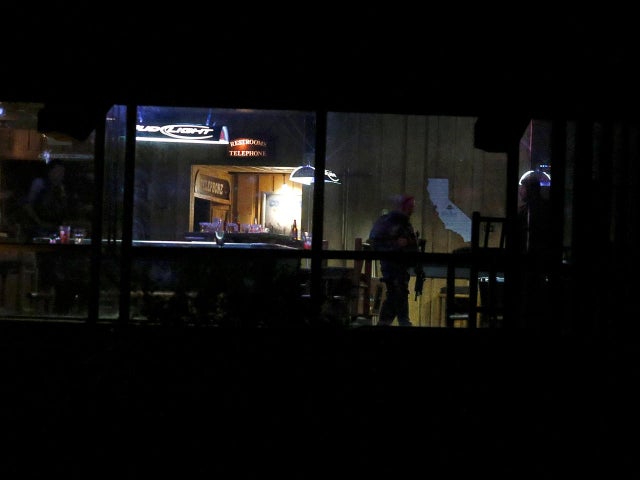 Police guard the site of a mass shooting at a bar in Thousand Oaks 