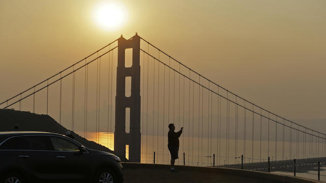 Mahmoud El Tahawy of Egypt looks out at smoke from wildfires obscuring the San Francisco skyline behind the Golden Gate Bridge Nov. 9, 2018, near Sausalito, California. 