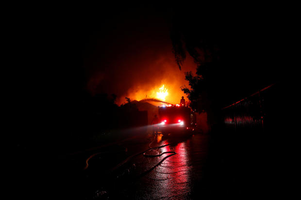 Firefighters battle flames overnight during a wildfire that burned dozens of homes in Thousand Oaks 