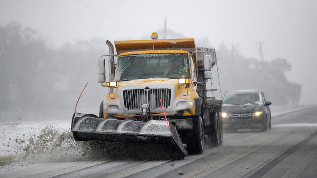 A plow clears snow from Road 438 in Douglas County near Lawrence, Kan., Nov. 25, 2018. 