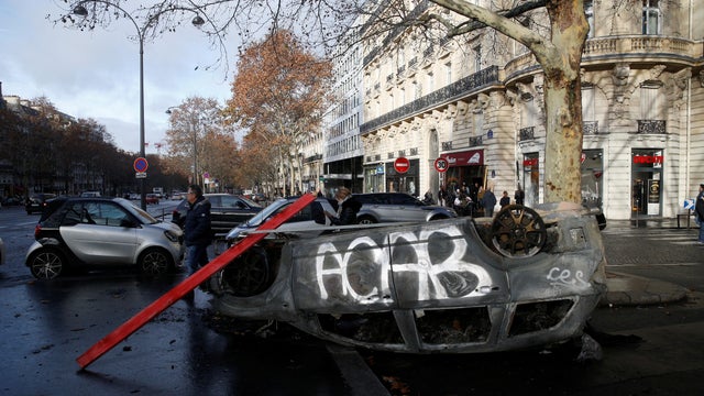 A vandalized car is seen the morning after clashes with protesters wearing yellow vests, a symbol of a French drivers' protest against higher diesel taxes, in Paris 