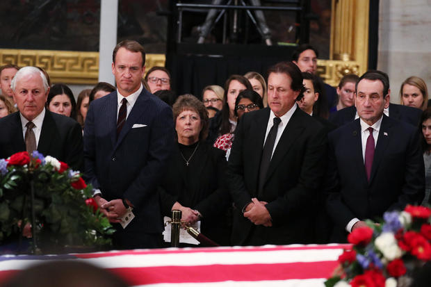 U.S. sports figures stand by the flag-draped casket of former U.S. President George H.W. Bush in Washington 