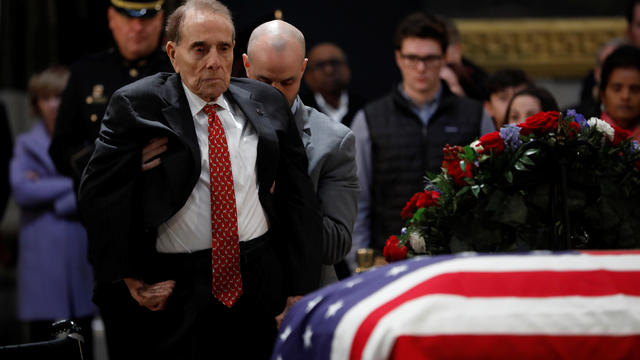 Former Senator Bob Dole pays his respects at the casket of former U.S. President George H.W. Bush as it lies in state inside the U.S. Capitol Rotunda on Capitol Hill in Washington 
