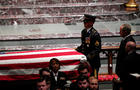 Former U.S. President George W. Bush looks on as casket of former U.S. President George H.W. Bush is carried at conclusion of funeral service in Houston 