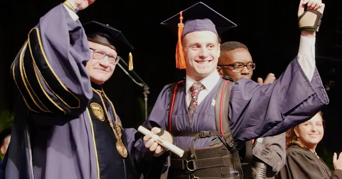 Quadriplegic student Aldo Amenta walks across stage at Florida