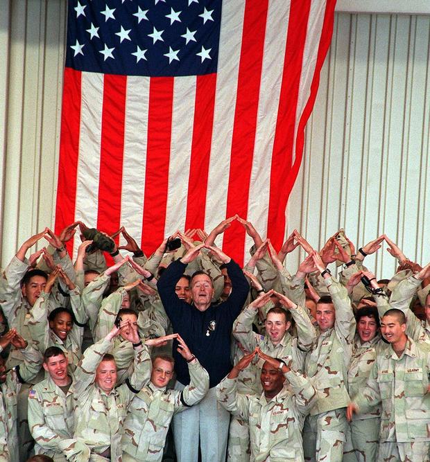 Former US President George Bush and troops of the 