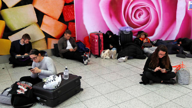 Passengers wait around in the South Terminal building at Gatwick Airport after drones flying illegally over the airfield forced the closure of the airport, in Gatwick 