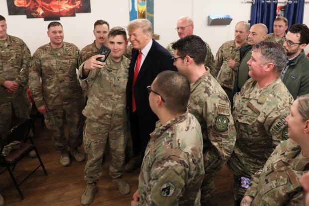 U.S. President Trump and the First Lady greet military personnel at the dining facility during an unannounced visit to Al Asad Air Base, Iraq