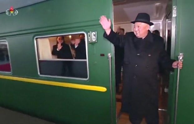 North Korean leader Kim Jong Un waves from his train before it departs from Pyongyang to make a trip to Beijing, China, Jan. 7, 2019
