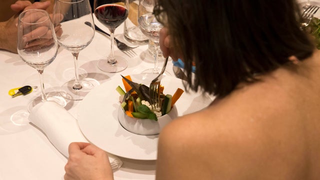 Diners eat in the nude at the nudist restaurant O'Naturel in Paris on Dec. 5, 2017. 