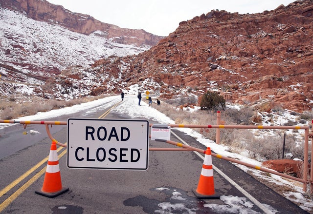 Hikers walk up the main road, which is closed because of the partial government shutdown, in Arches National Park, Utah 