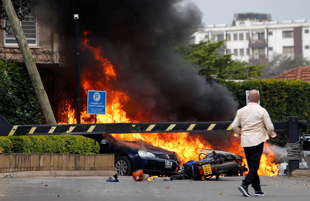 Cars are seen on fire at the scene where explosions and gunshots were heard at the Dusit hotel compound, in Nairobi 