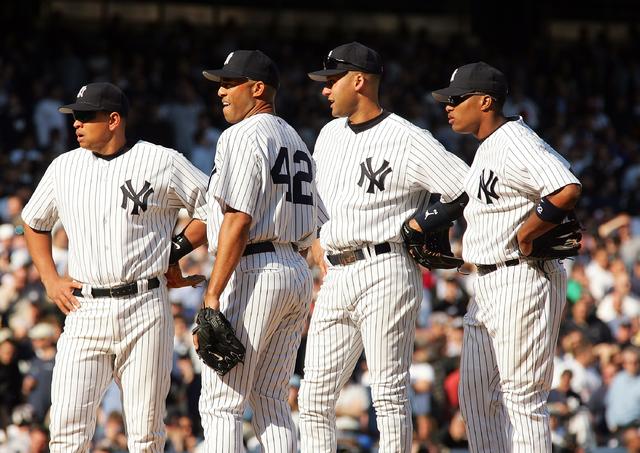 New York Yankees Derek Jeter and other Yankee players take the field to  start the game all wearing the #42 to honor Jackie Robinson on Jackie  Robinson Day in game 2 of