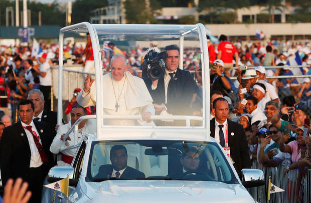 Pope Francis waves from his Popemobile as he arrives for a vigil at Saint Paul II Metro Park during World Youth Day in Panama City 