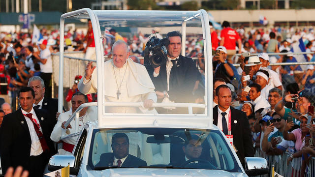 Pope Francis waves from his Popemobile as he arrives for a vigil at Saint Paul II Metro Park during World Youth Day in Panama City 