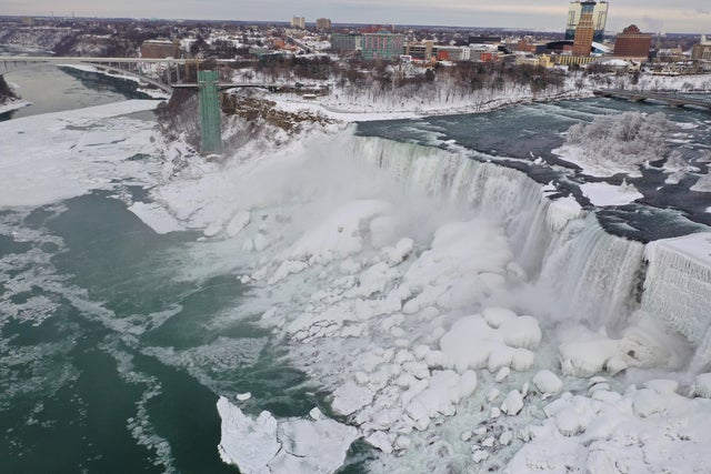 An aerial photo taken over the American side shows water flowing around ice due to subzero temperatures in Niagara Falls