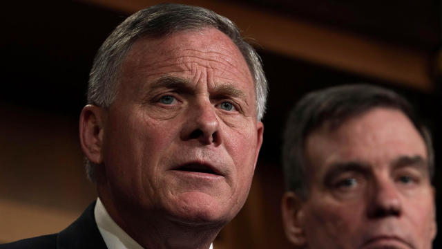 Senate Intelligence Committee Chairman Sen. Richard Burr, left, R-North Carolina, speaks as committee Vice Chairman Sen. Mark Warner, D-Virginia, listens during a news conference at the Capitol March 20, 2018, in Washington. 