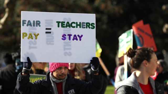 Oakland Unified School District students and teachers carry signs as they picket outside of Oakland Technical High School on Feb. 21, 2019, in Oakland, California. 