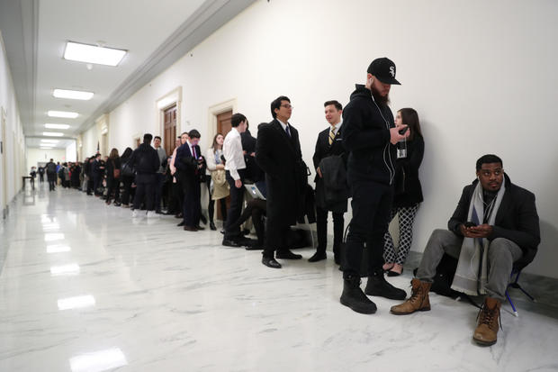 People line up inside the Rayburn House Office Building before Cohen testimony at House Oversight and Reform Committee hearing on Capitol Hill in Washington 