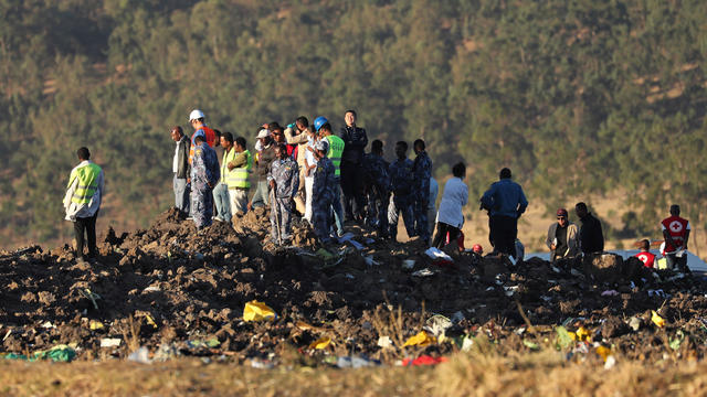 Members of the search and rescue mission look for dead bodies of passengers at the scene of the Ethiopian Airlines Flight ET 302 plane crash, near the town of Bishoftu 