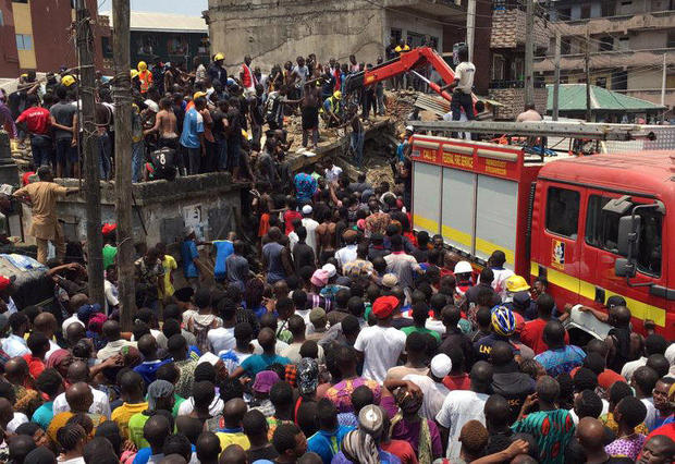 Rescue workers are seen at the site of a collapsed building containing a school in Nigeria's commercial capital of Lagos 