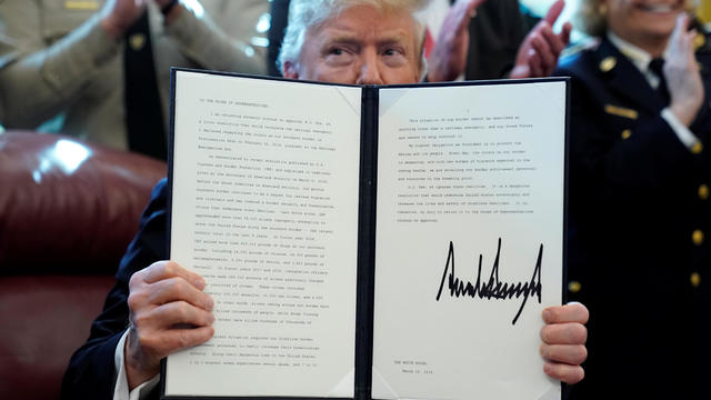 U.S. President Donald Trump holds up his veto of congressional resolution to end emergency declaration at the White House in Washington 