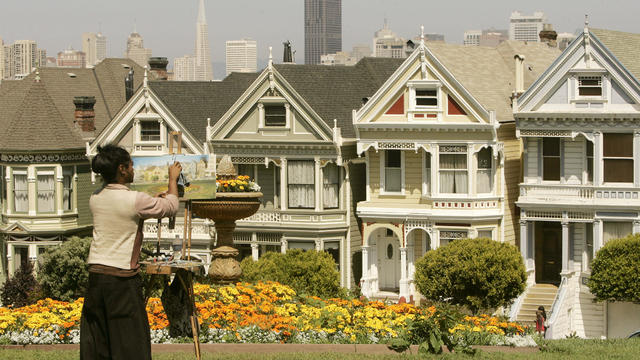 An artist paints the skyline of San Francisco, including Victorian homes known as the "Painted Ladies," in San Francisco 