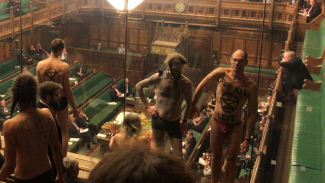 Extinction Rebellion activists strip in the House of Commons public gallery in London April 1, 2019, in this still image taken from social media video. 
