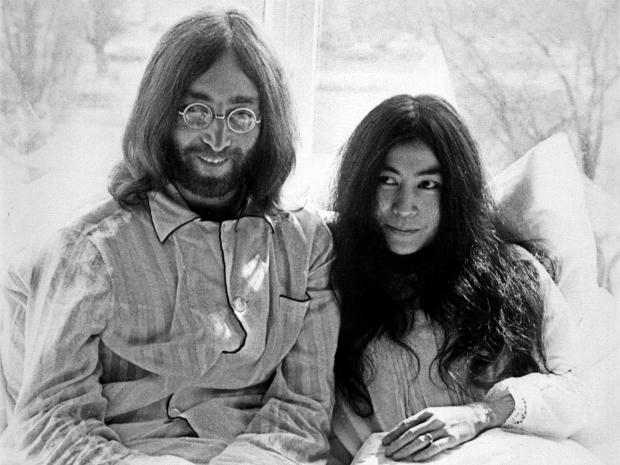 Beatles member John Lennon and his wife Yoko Ono receive journalists March 25, 1969, in the bedroom of their Hilton hotel suite in Amsterdam during their honeymoon in Europe. 