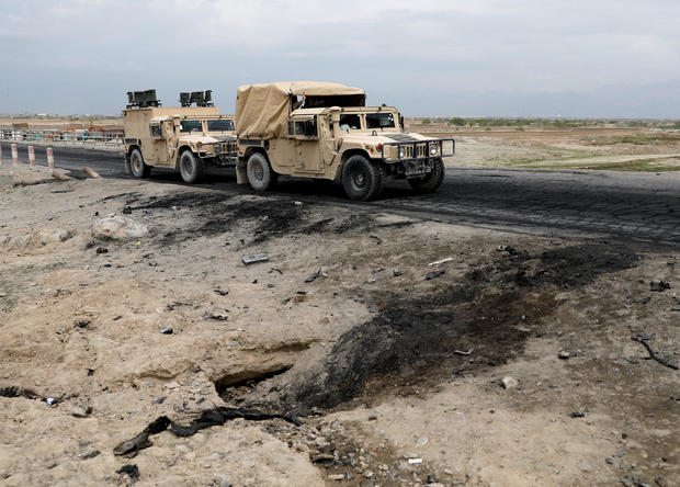 Afghan military convy past the site of a car bomb attack where U.S soldiers were killed near Bagram air base, Afghanistan 
