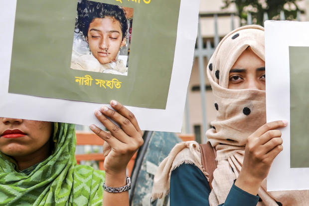 Bangladeshi women hold placards and photographs of schoolgirl Nusrat Jahan Rafi at a protest in Dhaka April 12, 2019, following her murder by being set on fire after she had reported a sexual assault. 