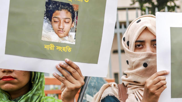 Bangladeshi women hold placards and photographs of schoolgirl Nusrat Jahan Rafi at a protest in Dhaka April 12, 2019, following her murder by being set on fire after she had reported a sexual assault. 